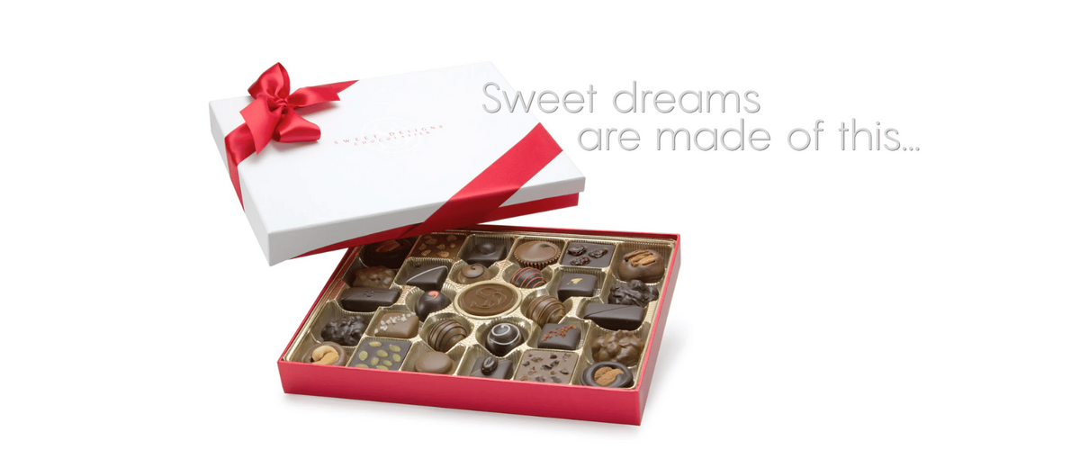 An open red gift box filled with assorted chocolates, shown beside a white lid tied with a red ribbon. Gray text on the right reads, 'Sweet dreams are made of this.