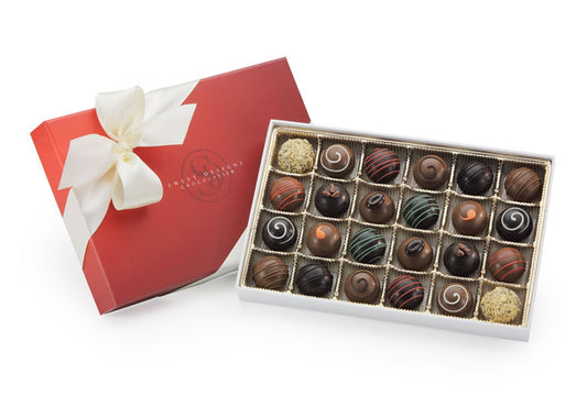 24 chocolate truffles in a gift box with a bow