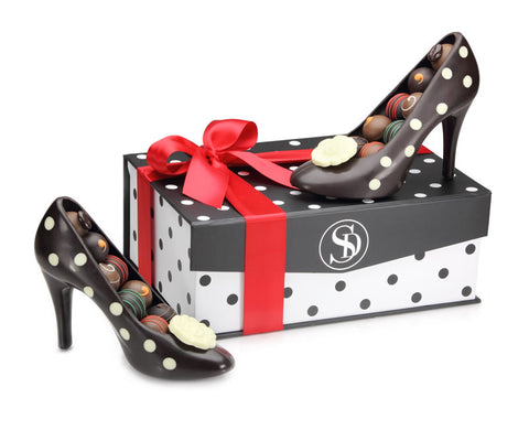 Two chocolate high heel pumps in a gift box