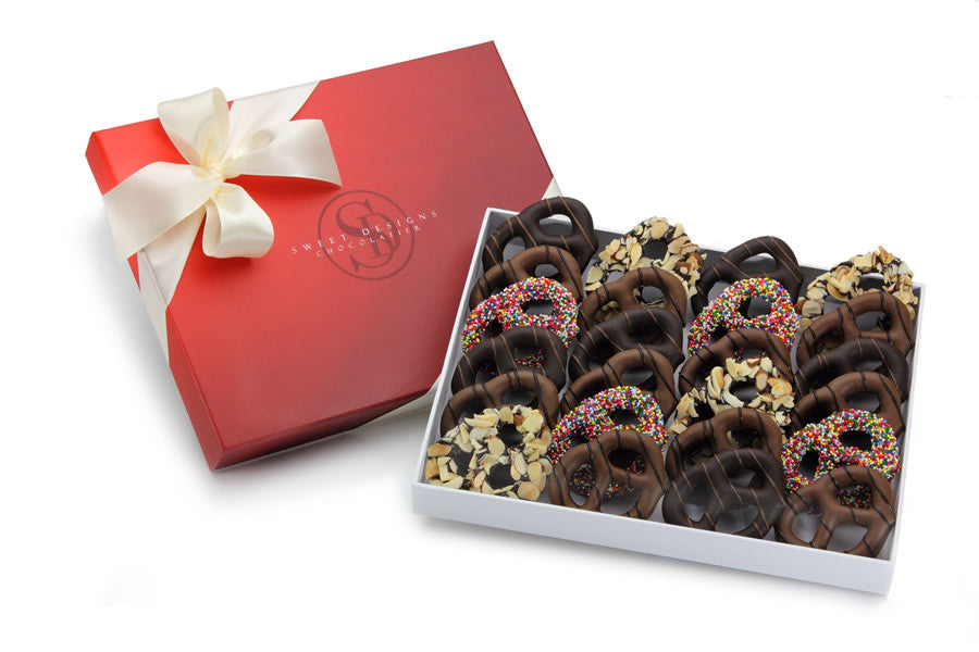 24 chocolate -covered pretzels in a gift box with a bow