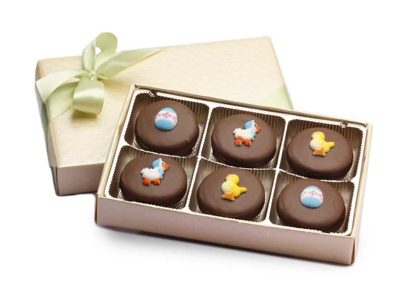 Six chocolate-covered Oreos with Easter decorations in a gift box