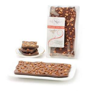 Milk chocolate bar topped with cinnamon-coated almond pieces