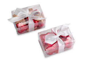 Chocolate hearts wrapped in foil in a gift box with a bow