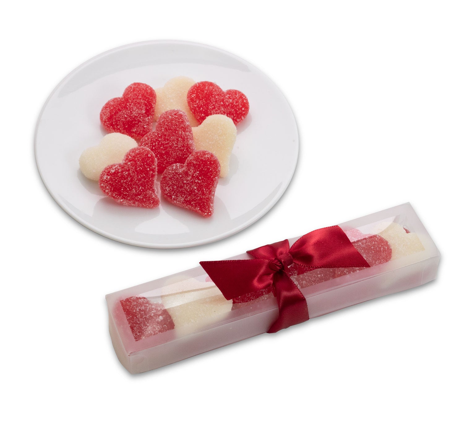 Red and white gummy hearts in a clear box with a bow