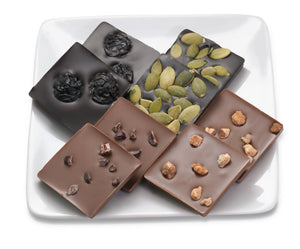 Milk chocolate squares with cinnamon almonds or cocoa nibs; dark chocolate with pepitas or tart cherries