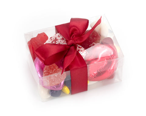 Chewy and chocolaty candies in a clear gift box with a bow