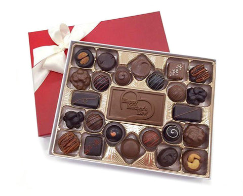 A gift box of chocolates with a happy mother's day bar in the center